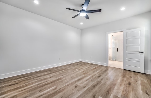 empty room featuring ceiling fan and light wood-type flooring