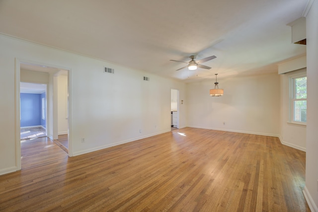 unfurnished room with crown molding, ceiling fan, and light wood-type flooring