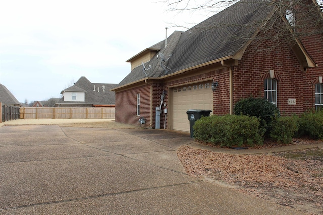 view of side of home featuring a garage