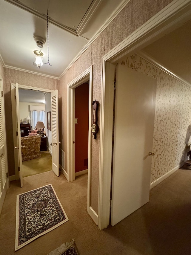 hallway featuring crown molding and light carpet