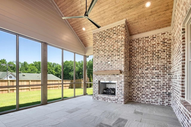9932 Whittmore Park Ln, Collierville, TN 38017 - unfurnished sunroom with a brick fireplace, ceiling fan, and lofted ceiling