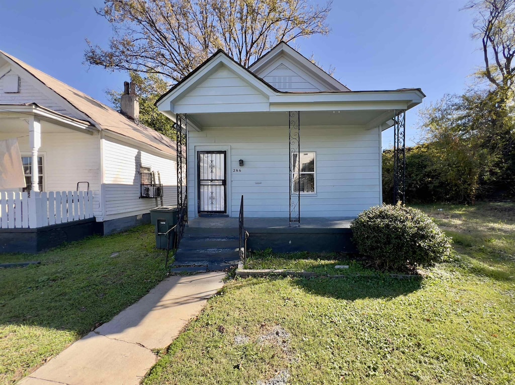 bungalow-style home with a front yard