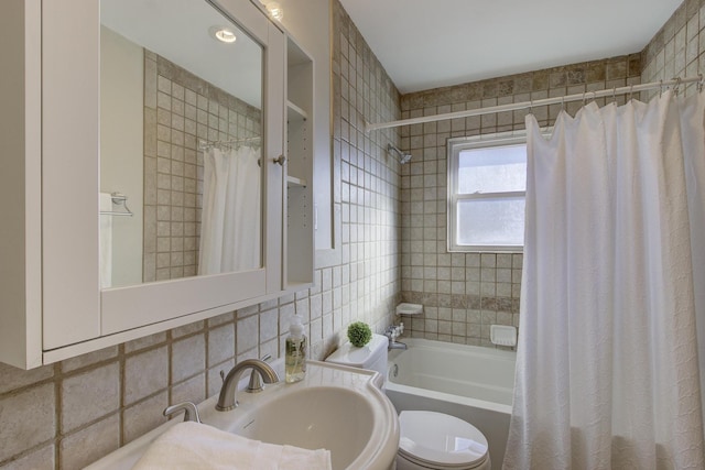 full bathroom with tasteful backsplash, sink, shower / tub combo, and toilet