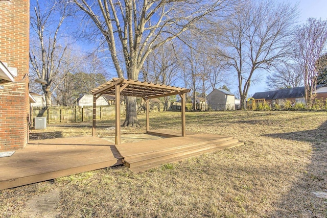 view of yard with a wooden deck, a pergola, and central air condition unit