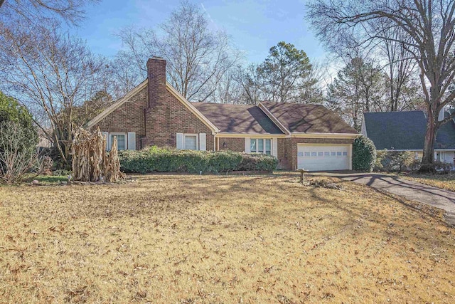 ranch-style home with a garage and a front lawn