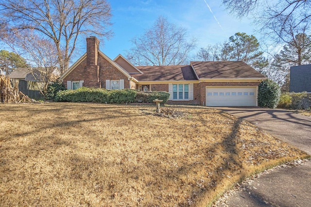 ranch-style house featuring a garage and a front yard