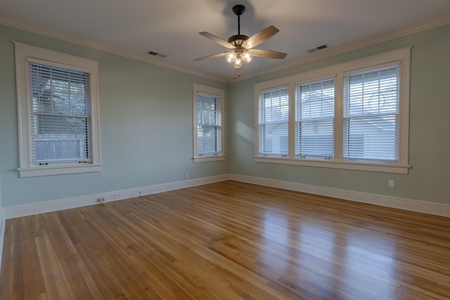 unfurnished room featuring wood-type flooring, ornamental molding, and ceiling fan