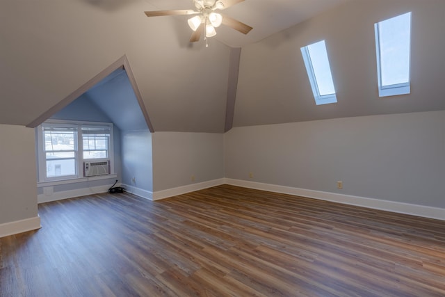 additional living space featuring cooling unit, ceiling fan, dark hardwood / wood-style flooring, and vaulted ceiling