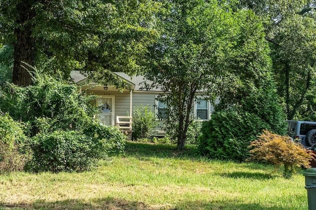 view of side of property with a lawn