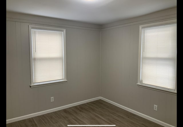 spare room featuring dark wood-type flooring