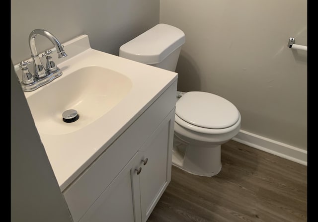 bathroom featuring hardwood / wood-style flooring, vanity, and toilet