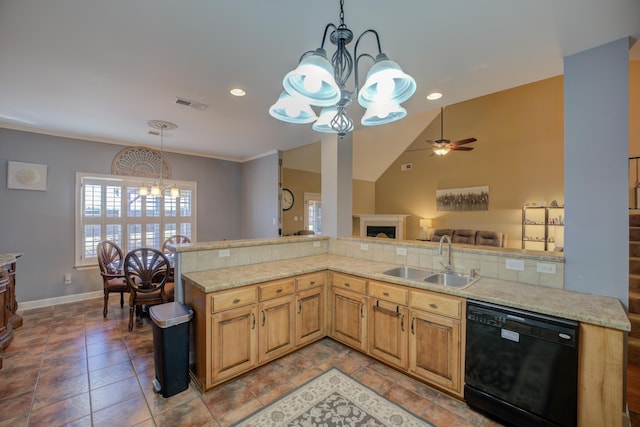 kitchen featuring pendant lighting, dishwasher, lofted ceiling, sink, and kitchen peninsula