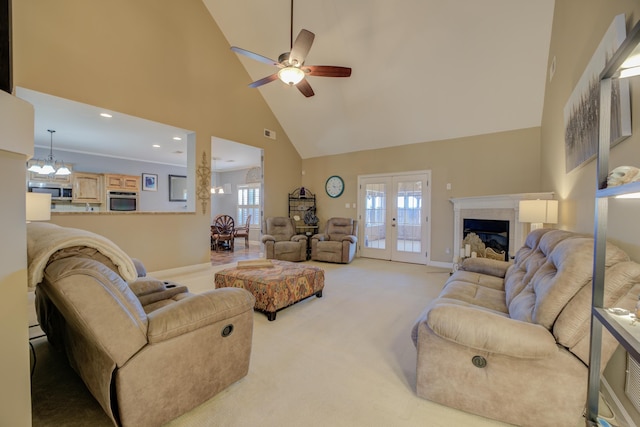 living room with french doors, carpet flooring, ceiling fan with notable chandelier, and high vaulted ceiling