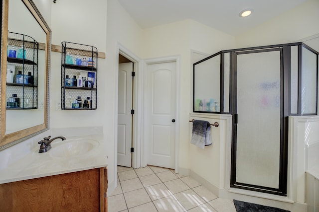 bathroom featuring tile patterned flooring, vanity, and walk in shower