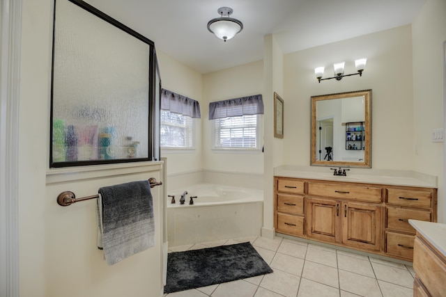 bathroom featuring a washtub, vanity, and tile patterned floors