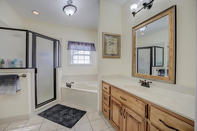 bathroom featuring independent shower and bath, vanity, and tile patterned floors