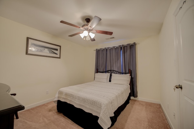 bedroom featuring ceiling fan and light carpet