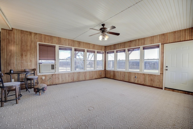 unfurnished sunroom featuring cooling unit and ceiling fan