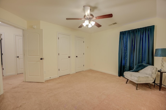 living area with vaulted ceiling, light carpet, and ceiling fan