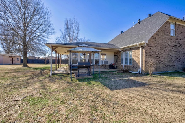 back of house with a gazebo, a yard, and a patio area