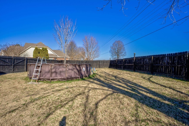 view of yard with a fenced in pool