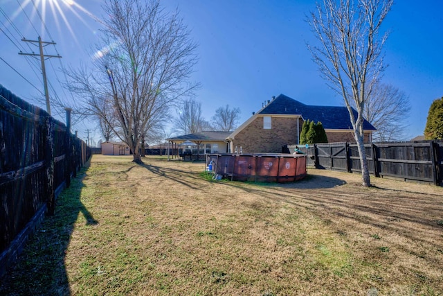 view of yard with a fenced in pool