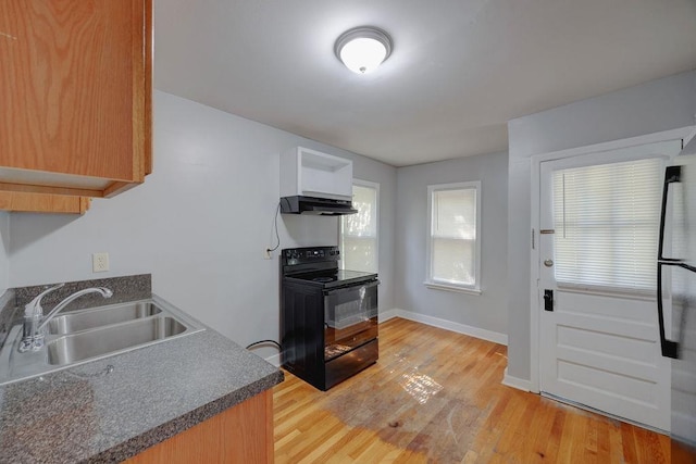 kitchen featuring sink, black electric range, and light hardwood / wood-style flooring