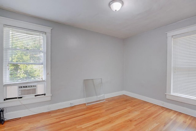 empty room with cooling unit and hardwood / wood-style flooring