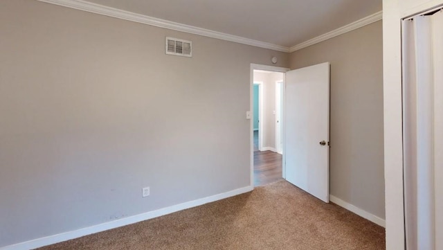 unfurnished room with light colored carpet and ornamental molding