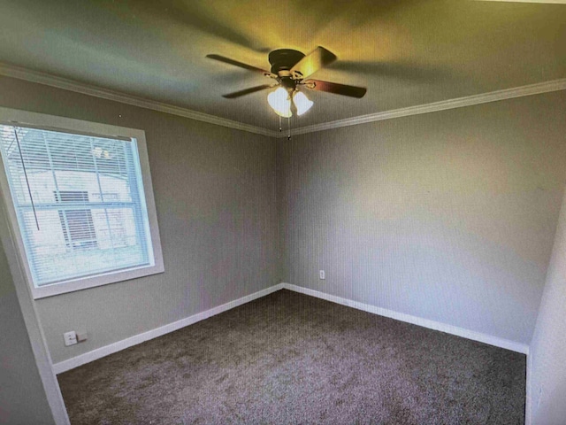 spare room featuring dark carpet, ornamental molding, and ceiling fan