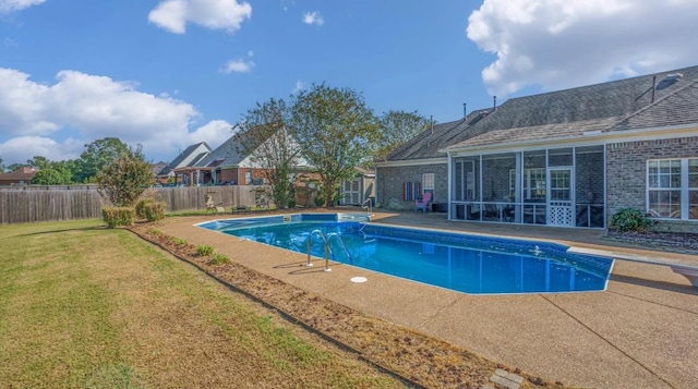 view of swimming pool featuring a patio, a yard, a sunroom, and a diving board