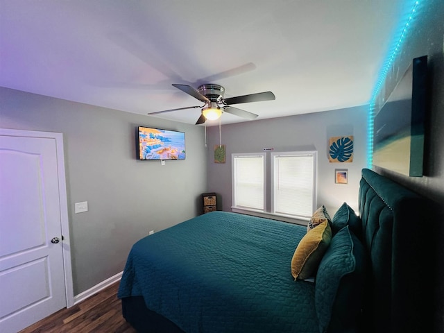 bedroom with dark hardwood / wood-style flooring and ceiling fan