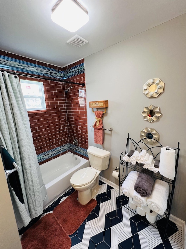 bathroom with shower / bath combo and toilet