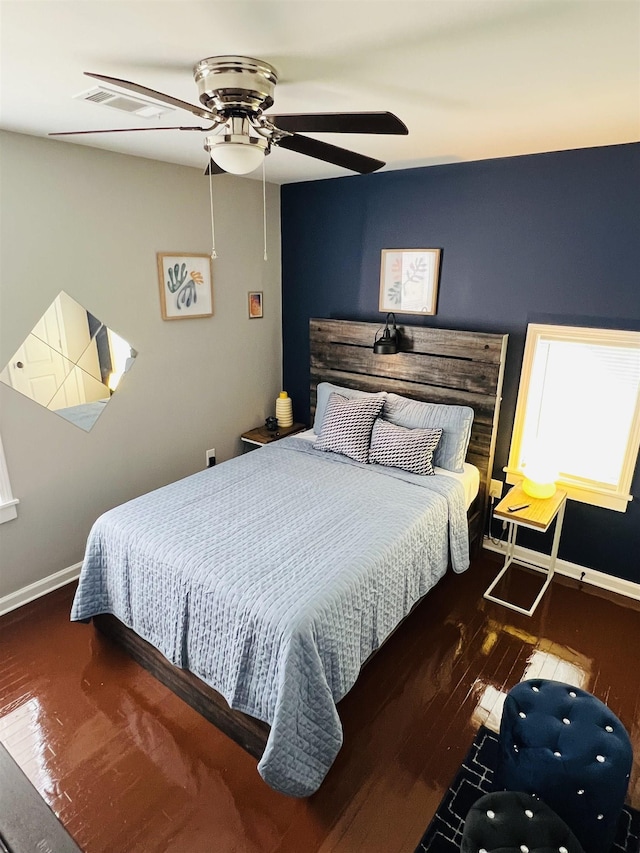 bedroom with dark hardwood / wood-style flooring and ceiling fan