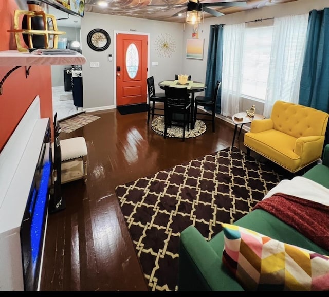 living room with dark wood-type flooring and ceiling fan