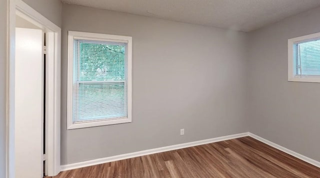 spare room with hardwood / wood-style floors and a textured ceiling