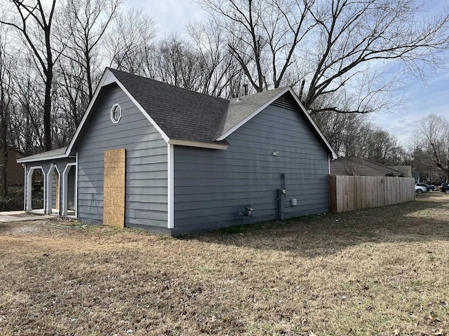 view of property exterior featuring a garage and a yard