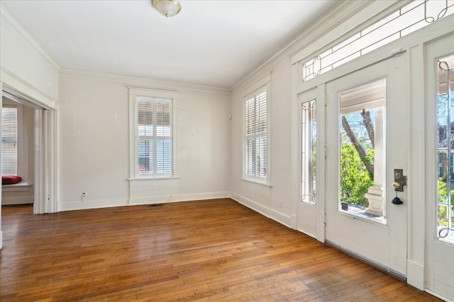 doorway to outside with wood-type flooring and crown molding