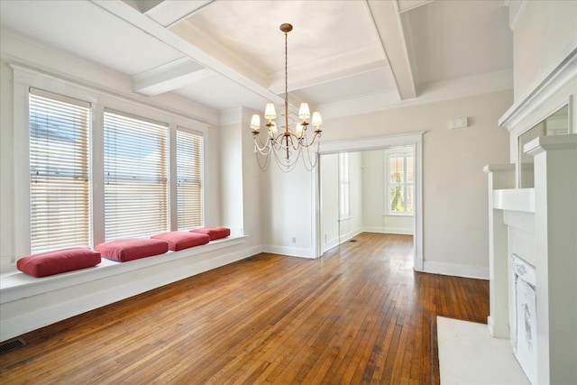 unfurnished dining area featuring coffered ceiling, hardwood / wood-style floors, beam ceiling, and a healthy amount of sunlight