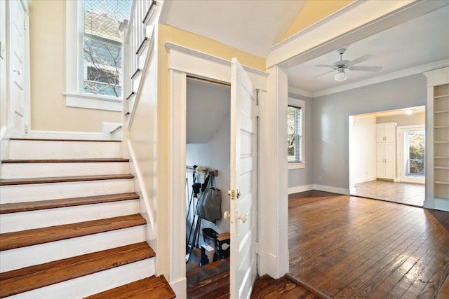 staircase with hardwood / wood-style flooring, ceiling fan, ornamental molding, and vaulted ceiling