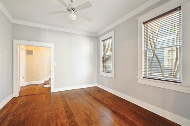 unfurnished room featuring hardwood / wood-style flooring, crown molding, and a healthy amount of sunlight