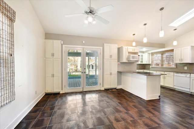 kitchen with white appliances, hanging light fixtures, white cabinets, decorative backsplash, and french doors