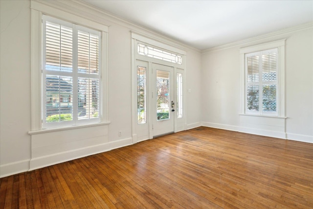 foyer with crown molding, hardwood / wood-style flooring, and a wealth of natural light