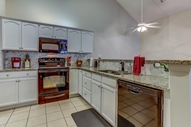 kitchen with black appliances and white cabinets