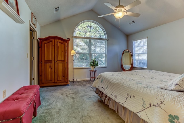 bedroom with multiple windows, ceiling fan, lofted ceiling, and carpet