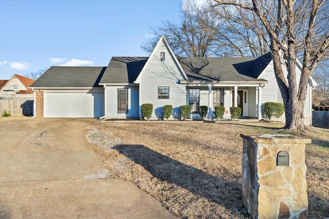 view of front of house with a garage, a porch, and a front yard