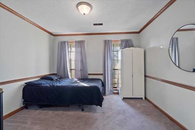 carpeted bedroom featuring crown molding and a textured ceiling