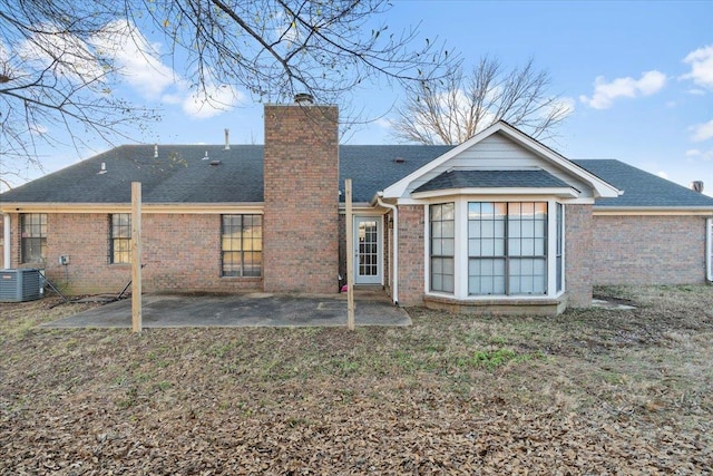 back of property with a patio area and central air condition unit