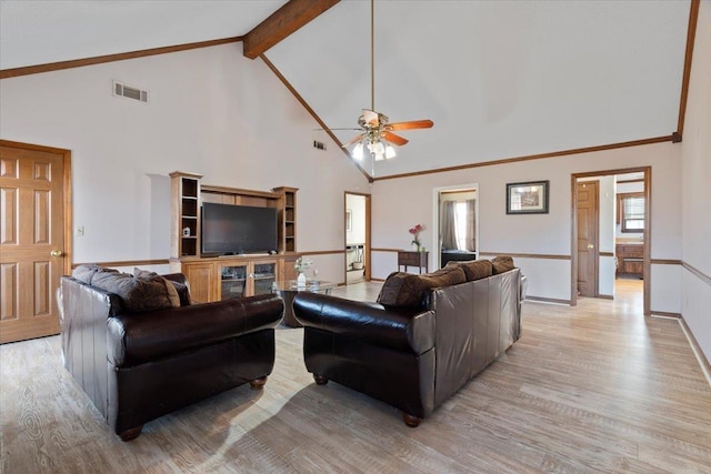 living room featuring beam ceiling, high vaulted ceiling, a wealth of natural light, and light wood-type flooring