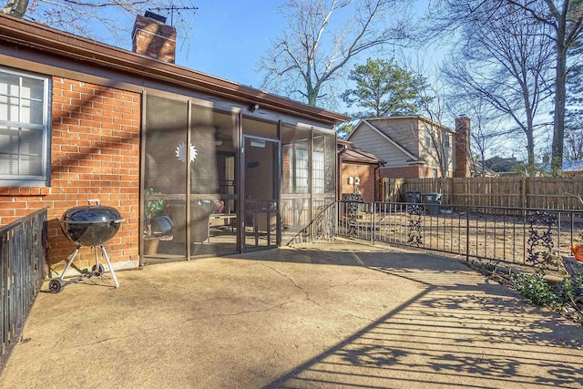 back of property featuring a patio area and a sunroom